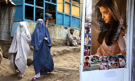 Afghan women wearing burqas walk towards a market in the center of Kabul.